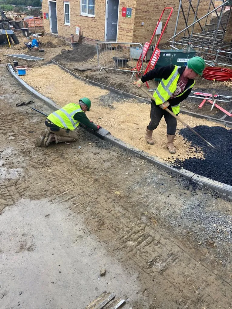 Site preparation with kerb laying and surfacing on a housing development